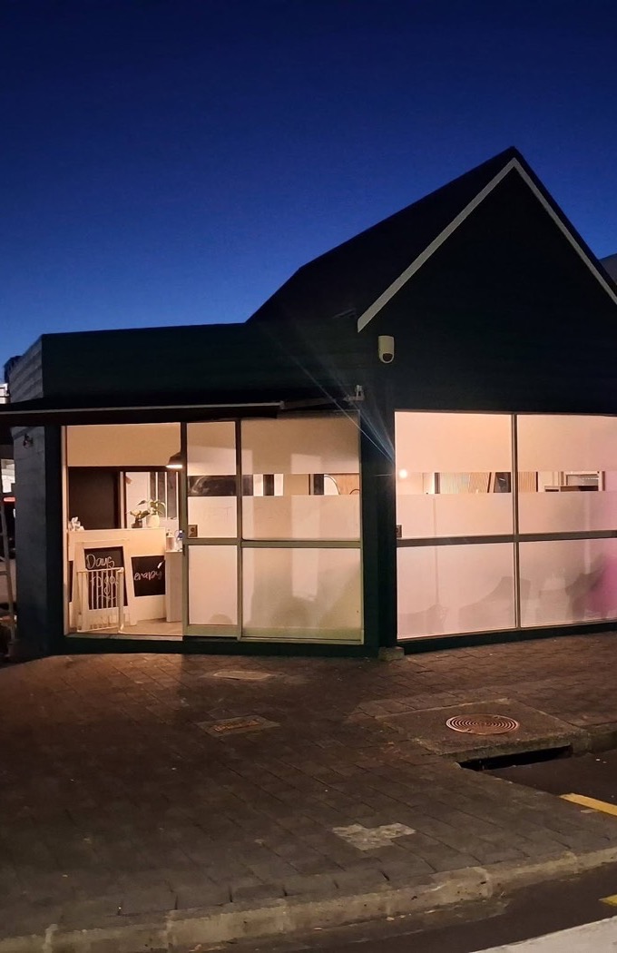 SP Hair Therapy shopfront at dusk, with warm light glowing in the windows